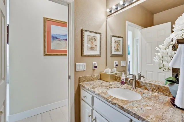 a view of a patio with a dining table and chairs with potted plants