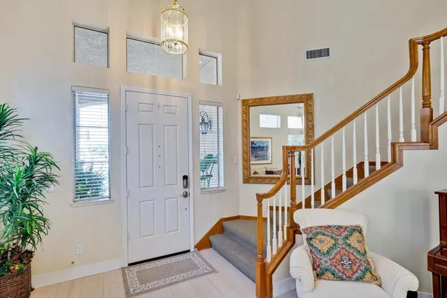 a view of an entryway with wooden floor and front door