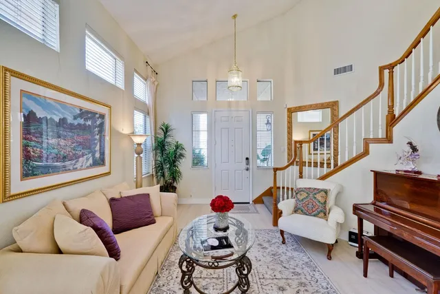 a living room with furniture and a chandelier