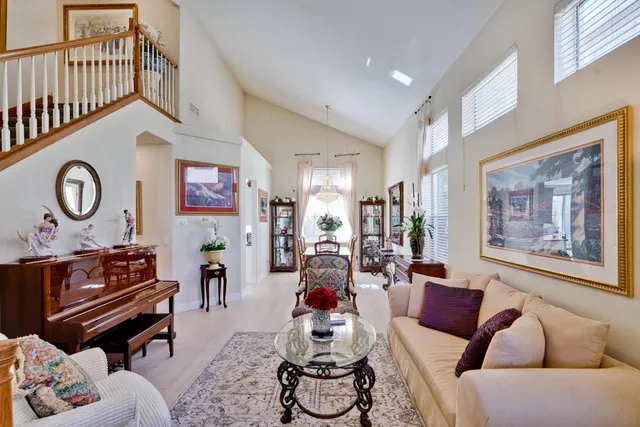 a living room with furniture a rug and a window