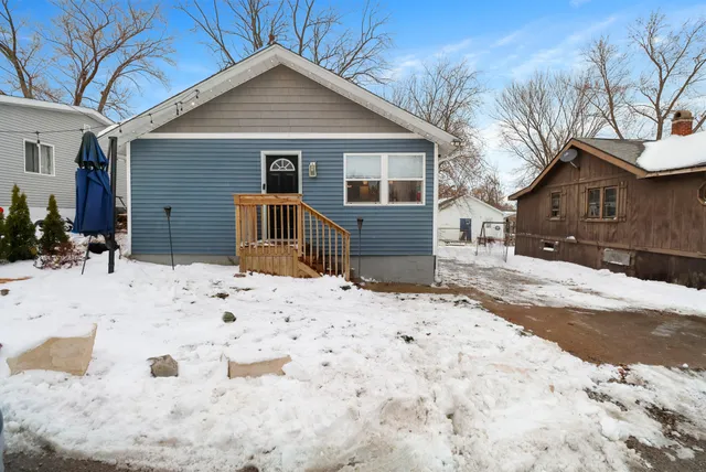 a view of a house with snow on the road