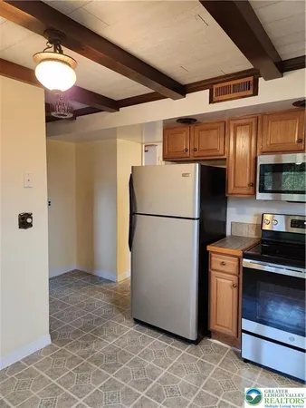a kitchen with a refrigerator and a stove