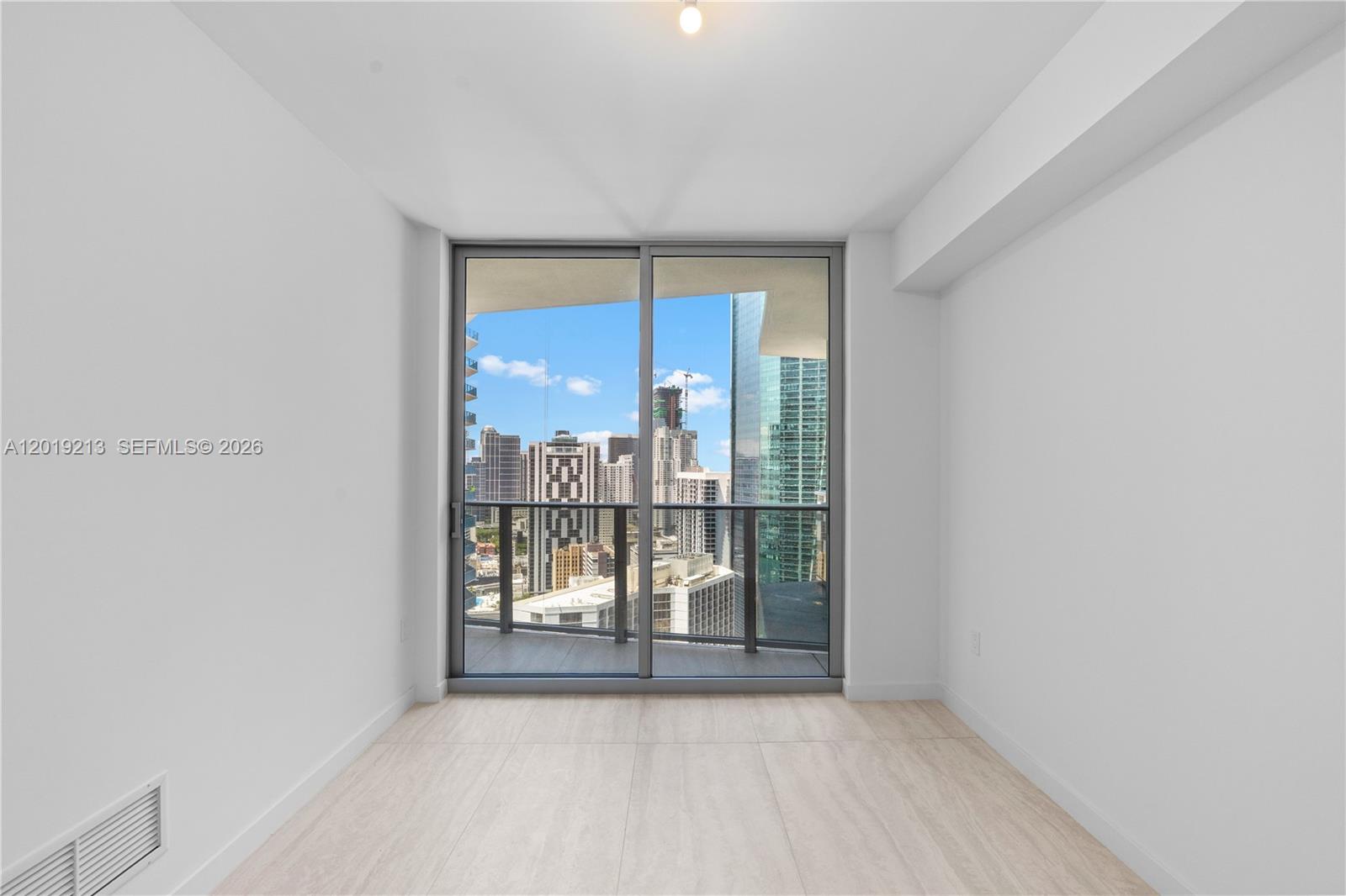 77 Southeast 5th, Unit 3702 Miami, FL 33131 - Photo 27 of 63 wooden floor in an empty room with a window