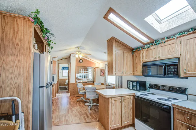 a kitchen with a stove a sink and a refrigerator