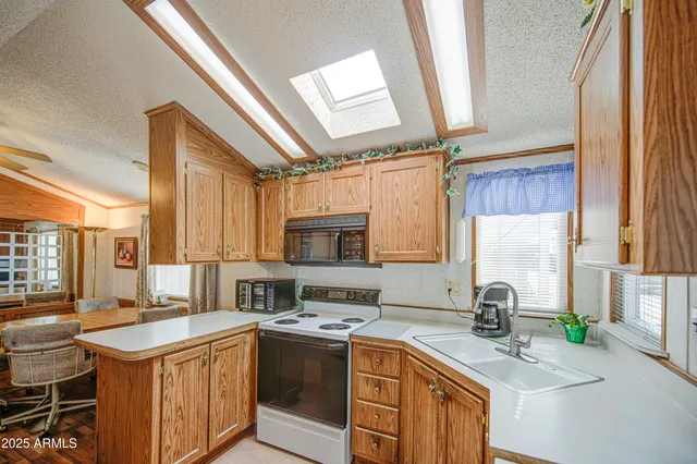 a kitchen with a sink stove top oven and cabinets