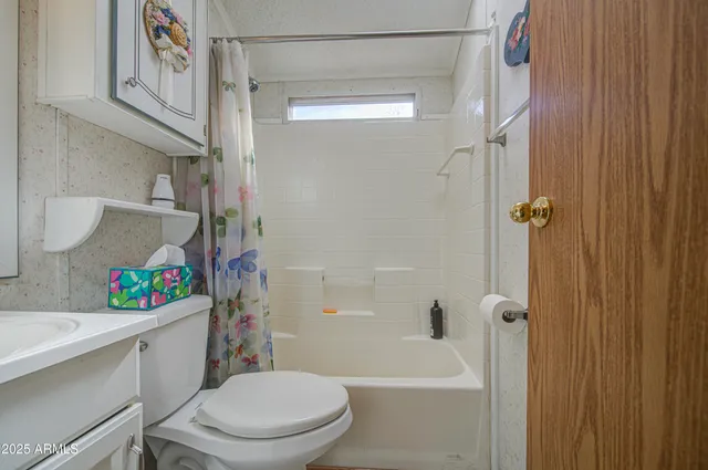 a white toilet sitting next to a bathroom sink