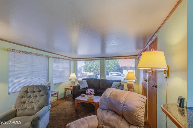 a living room with furniture fireplace and a large window