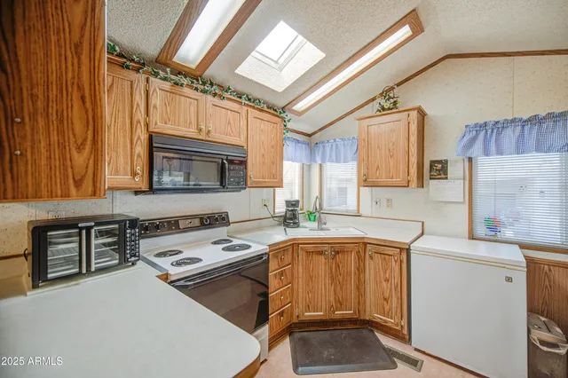 a kitchen with a stove a sink and a microwave