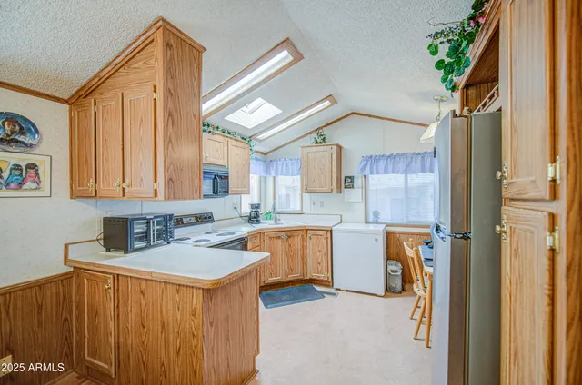 a kitchen that has a sink and a stove in it