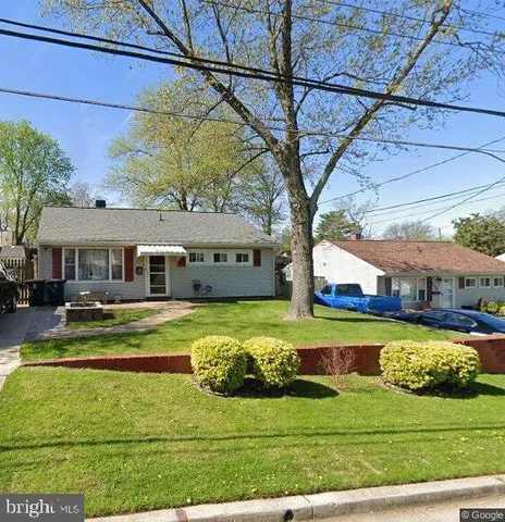 a front view of a house with a yard table and chairs