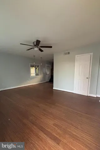 a view of a ceiling fan and wooden floor