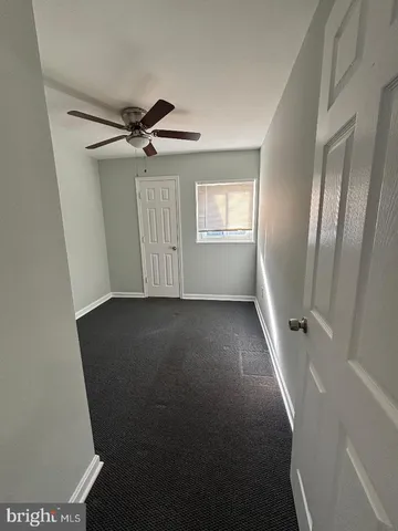en view of room with window and hardwood floor