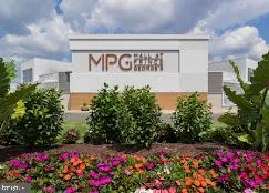 a sign that is in front of flowers