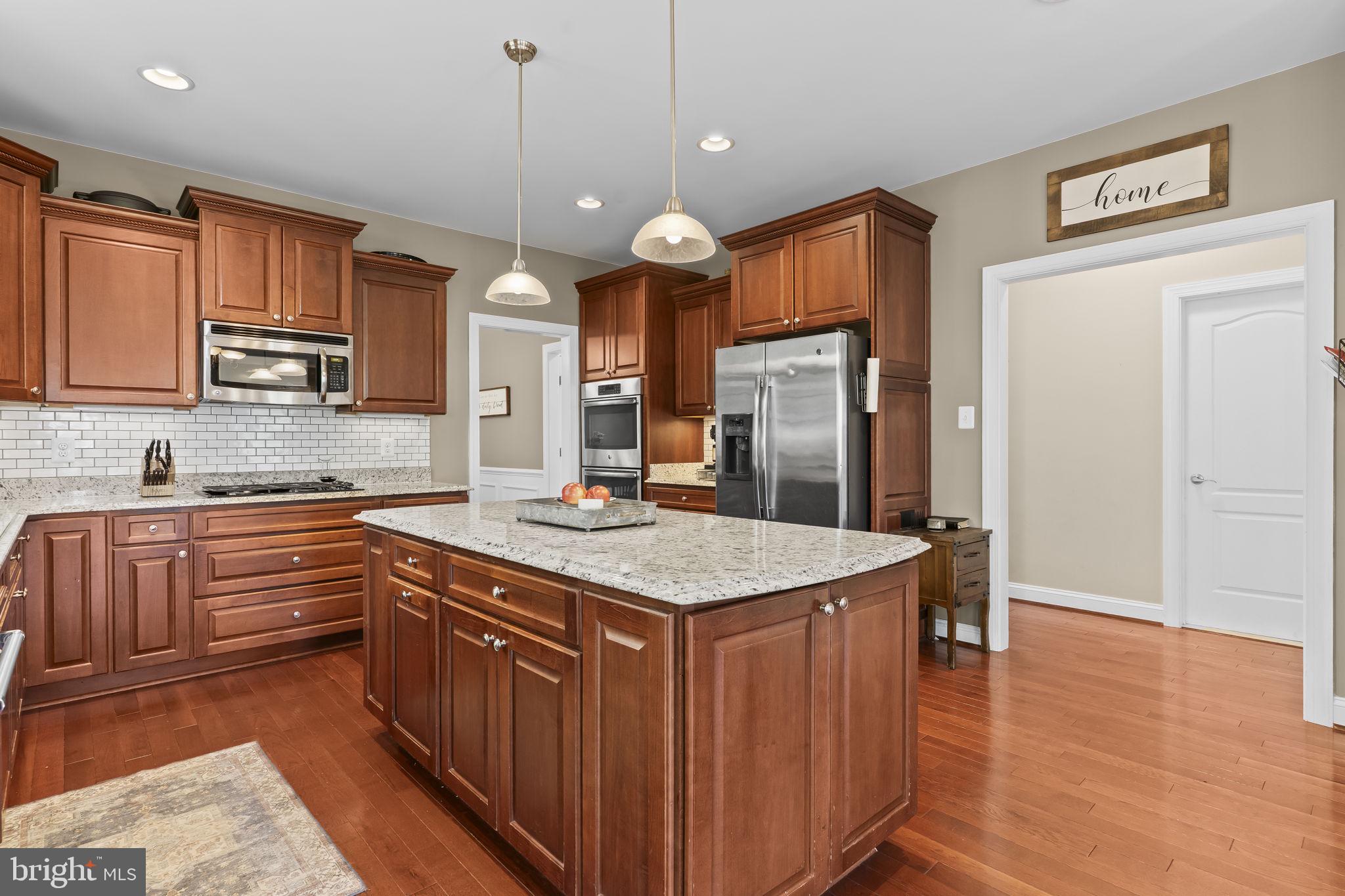 1905 Resting Ridge Lane Prince Frederick, MD 20678 - Photo 15 of 91 a kitchen with stainless steel appliances granite countertop a sink a stove and a refrigerator
