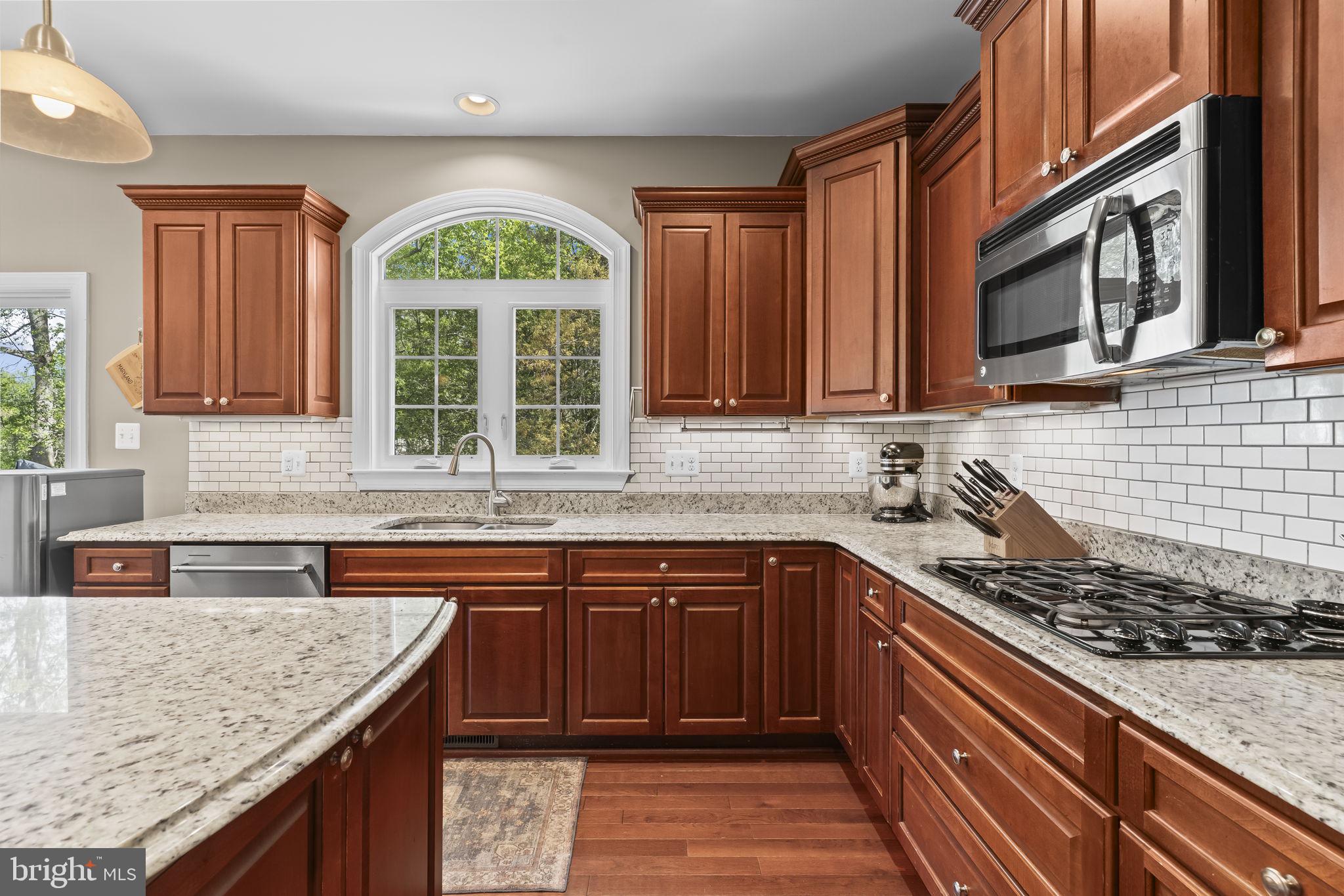 1905 Resting Ridge Lane Prince Frederick, MD 20678 - Photo 17 of 91 a kitchen with stainless steel appliances granite countertop a sink stove and cabinets