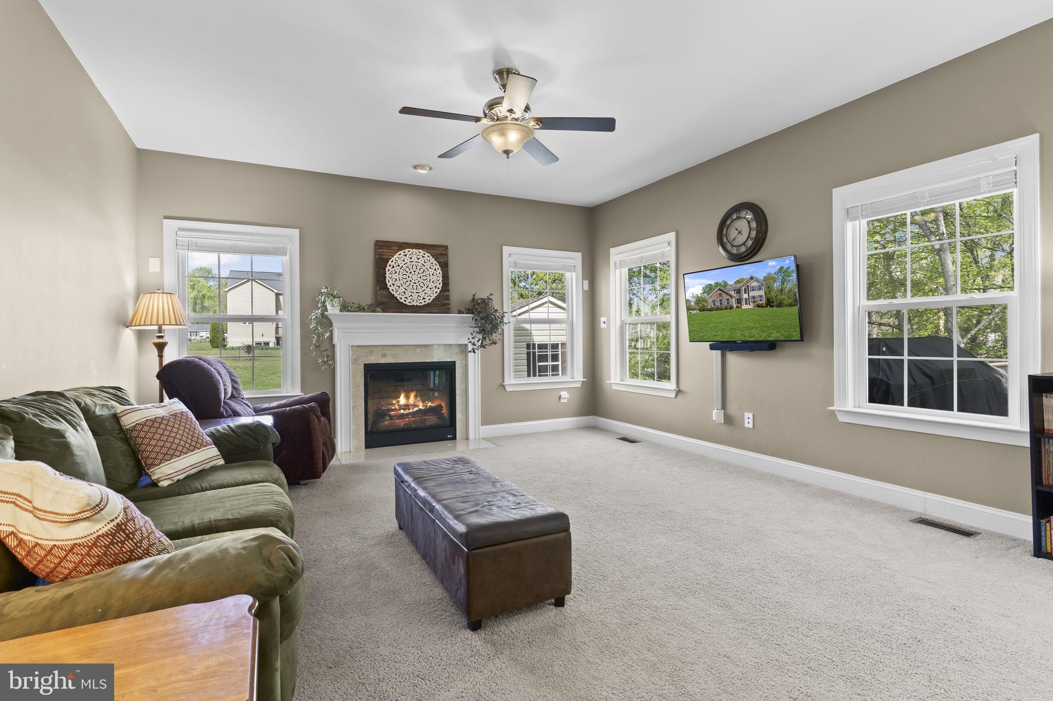 1905 Resting Ridge Lane Prince Frederick, MD 20678 - Photo 22 of 91 a living room with furniture and a fireplace