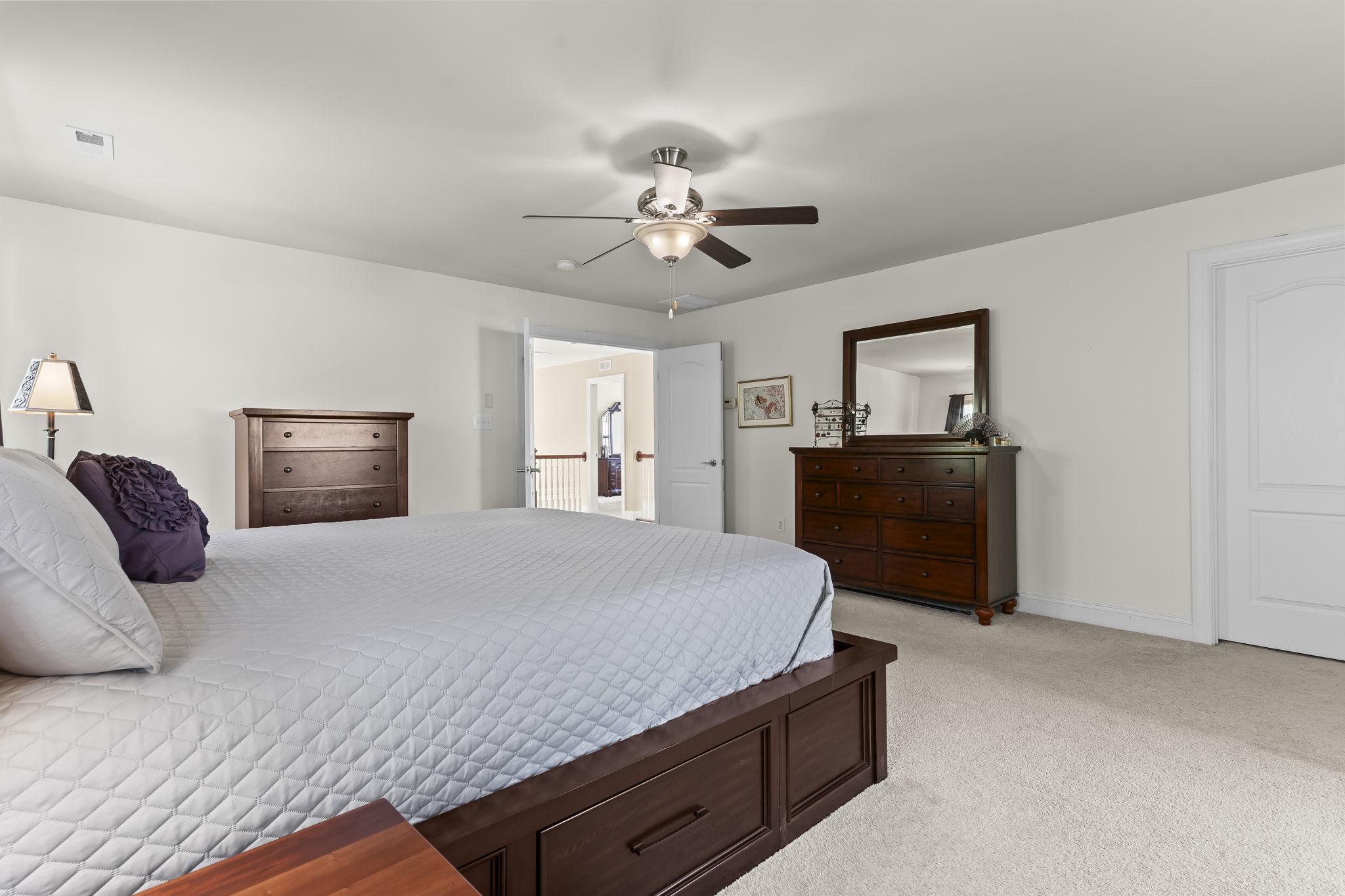 1905 Resting Ridge Lane Prince Frederick, MD 20678 - Photo 33 of 91 a bedroom with a large bed and dresser