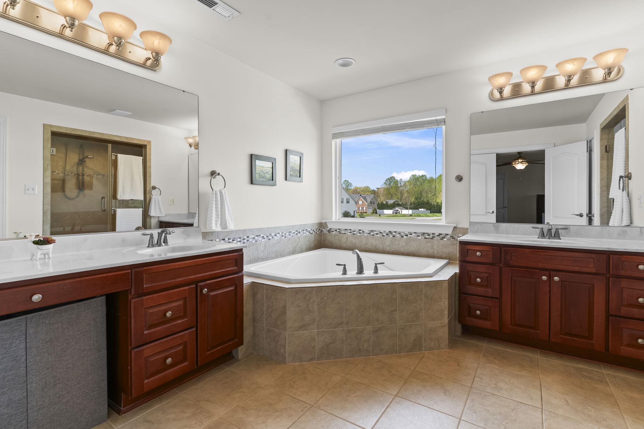 1905 Resting Ridge Lane Prince Frederick, MD 20678 - Photo 34 of 91 a spacious bathroom with a tub sink and mirror