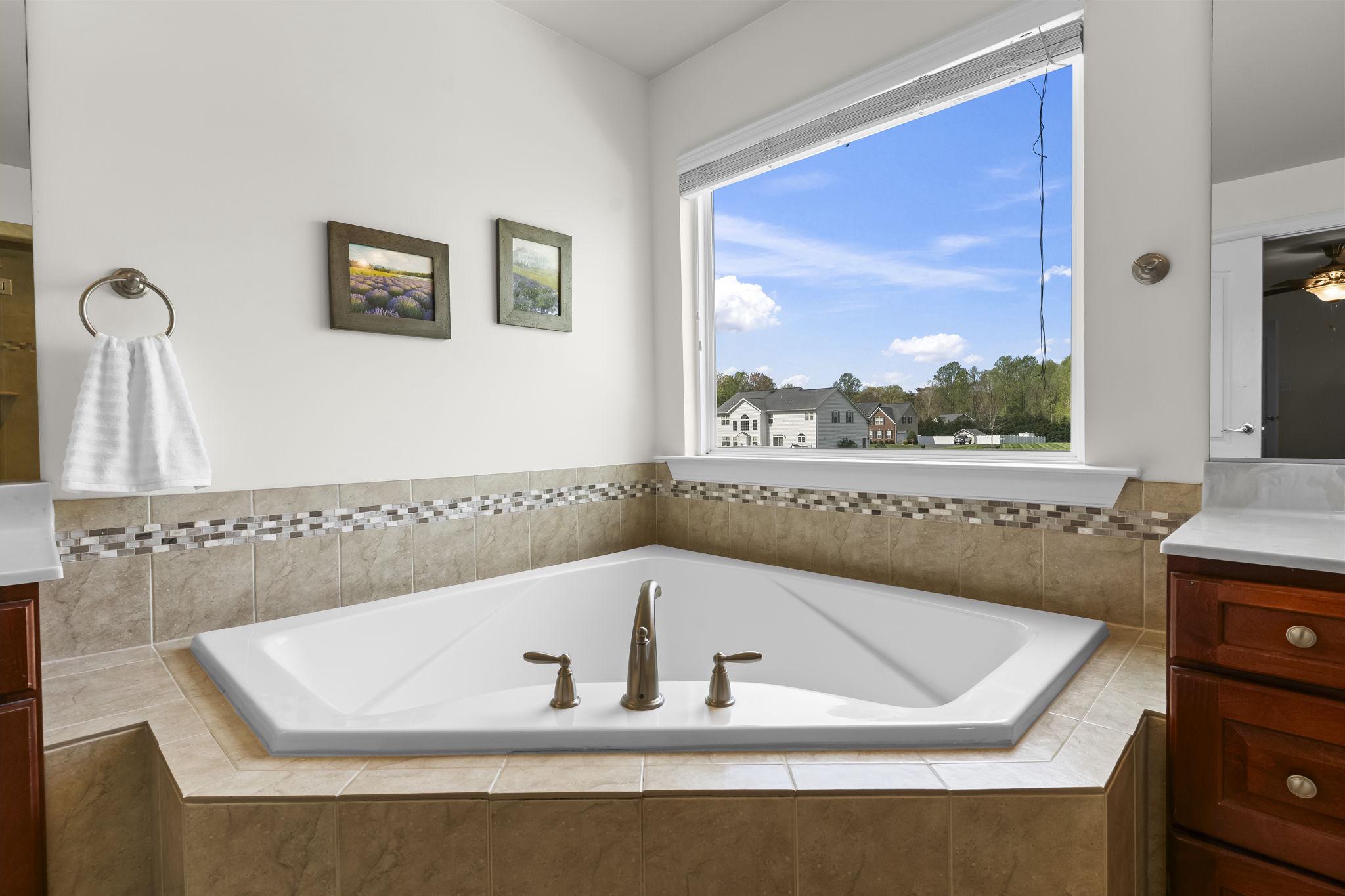 1905 Resting Ridge Lane Prince Frederick, MD 20678 - Photo 35 of 91 a bath tub sitting in a bathroom next to a window