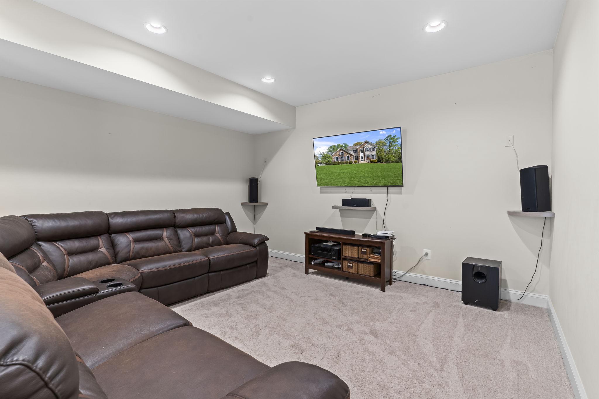 1905 Resting Ridge Lane Prince Frederick, MD 20678 - Photo 50 of 91 a living room with furniture a flat screen tv and a couch