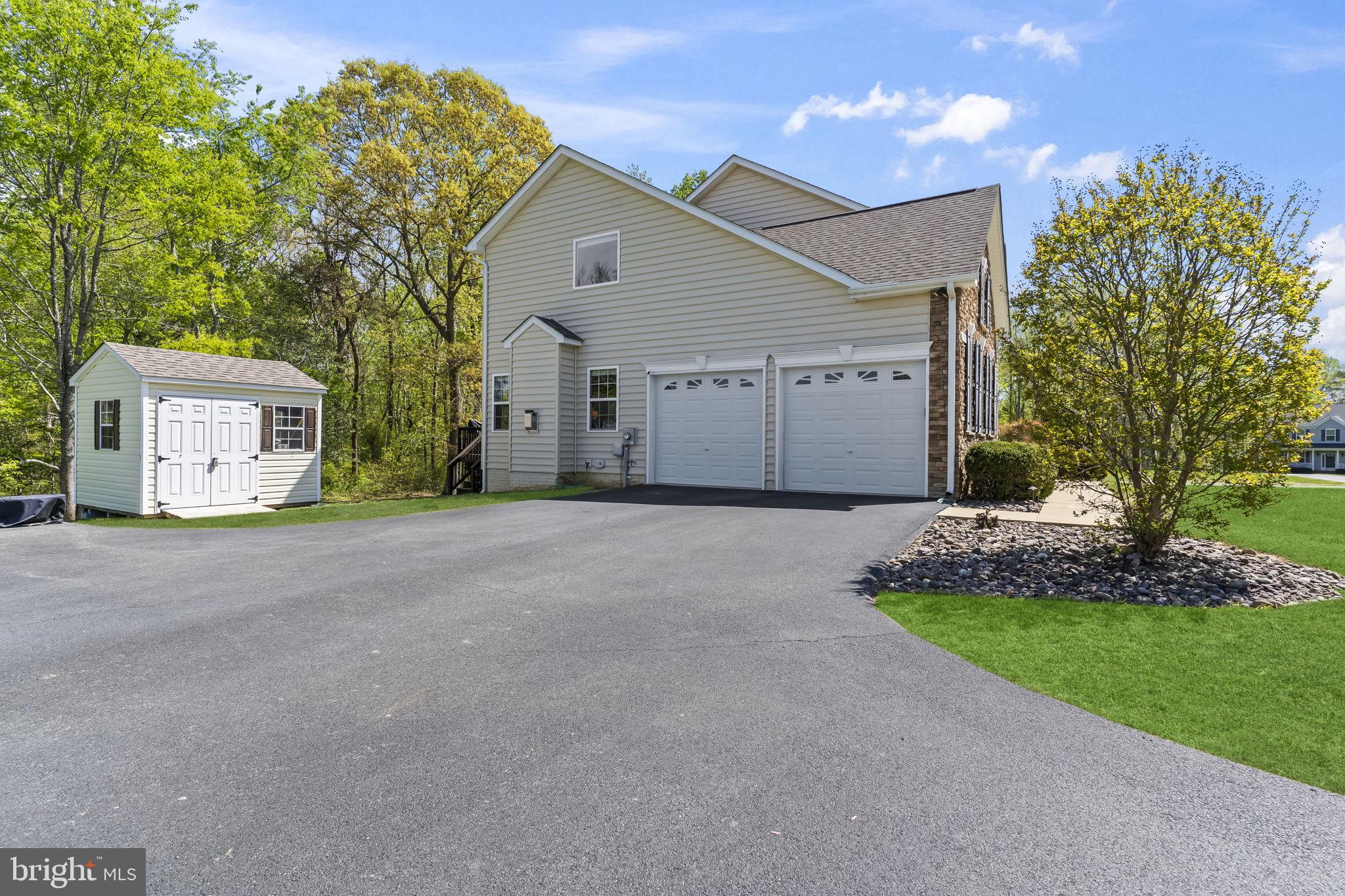 1905 Resting Ridge Lane Prince Frederick, MD 20678 - Photo 63 of 91 a view of a house with a yard and garage
