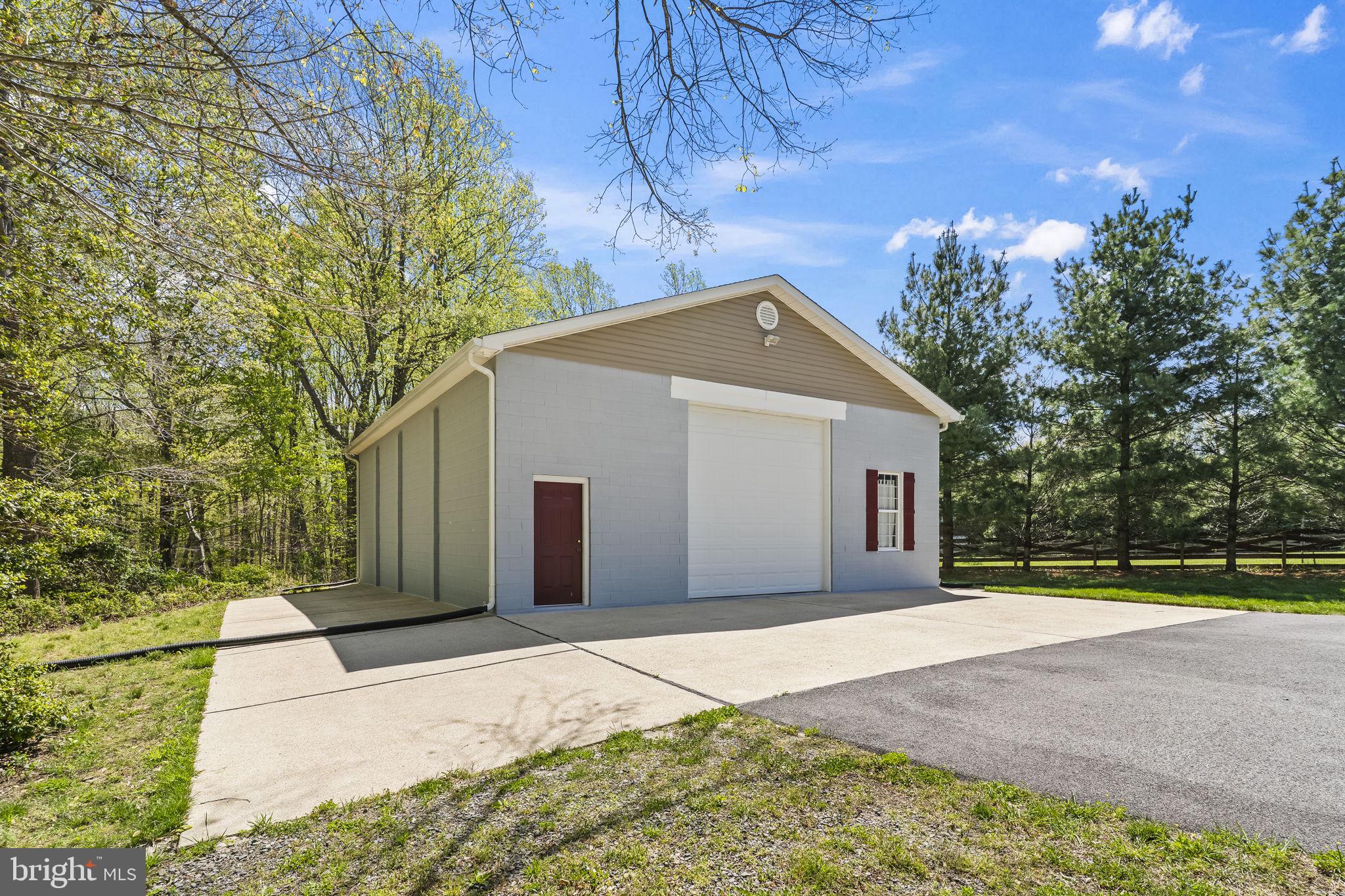 1905 Resting Ridge Lane Prince Frederick, MD 20678 - Photo 78 of 91 a front view of a house with a yard and garage