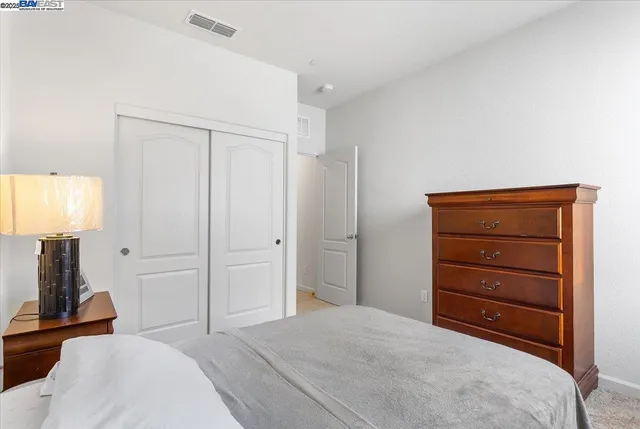 a bedroom with a bed and a mirror