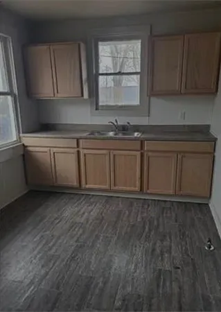 a kitchen with granite countertop a sink and a stove