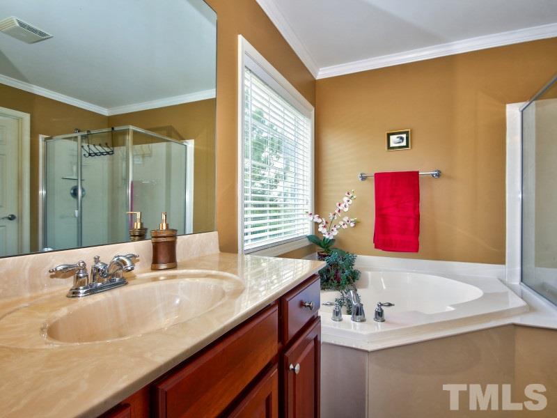 5304 Jade Forest Trail Raleigh, NC 27616 - Photo 17 of 22 a bathroom with a granite countertop sink and a mirror