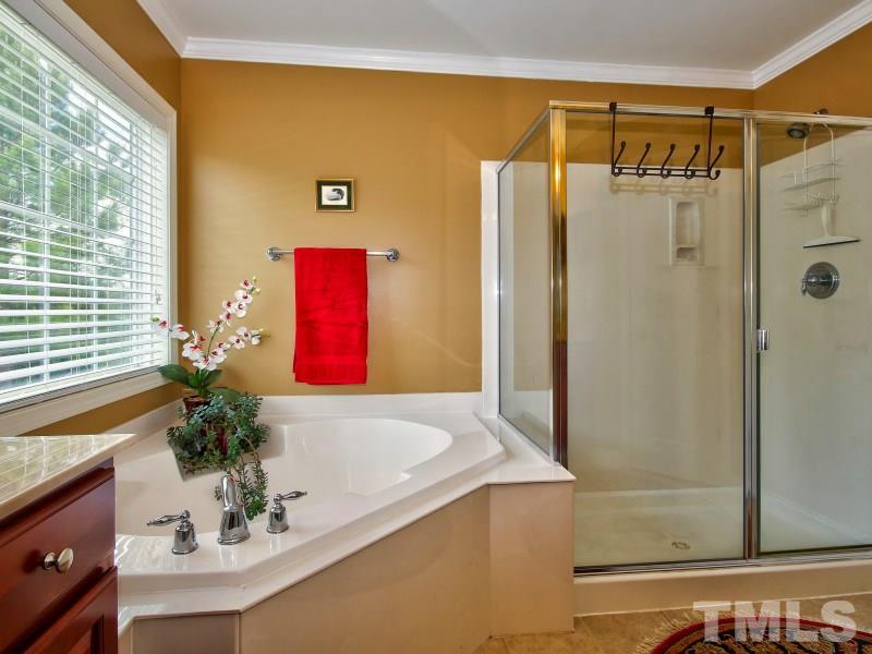 5304 Jade Forest Trail Raleigh, NC 27616 - Photo 18 of 22 a bathroom with a shower curtain and a large mirror