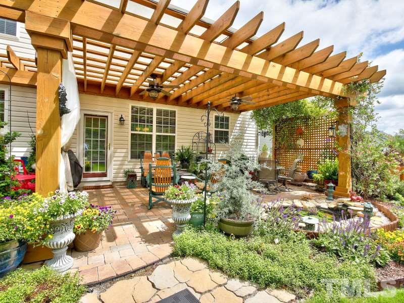 5304 Jade Forest Trail Raleigh, NC 27616 - Photo 4 of 22 a view of a patio with table and chairs and potted plants