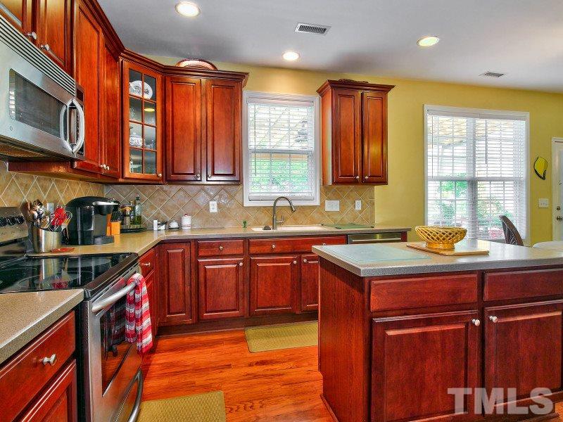 5304 Jade Forest Trail Raleigh, NC 27616 - Photo 8 of 22 a kitchen with stainless steel appliances granite countertop a sink stove and cabinets