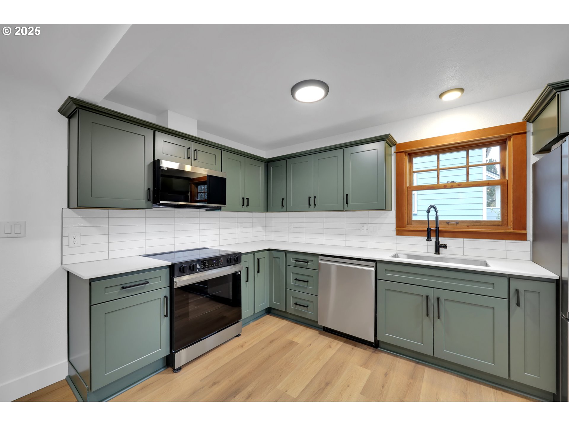 2121 Jefferson Street Eugene, OR 97405 - Photo 14 of 35 a kitchen with stainless steel appliances granite countertop a sink and stove top oven