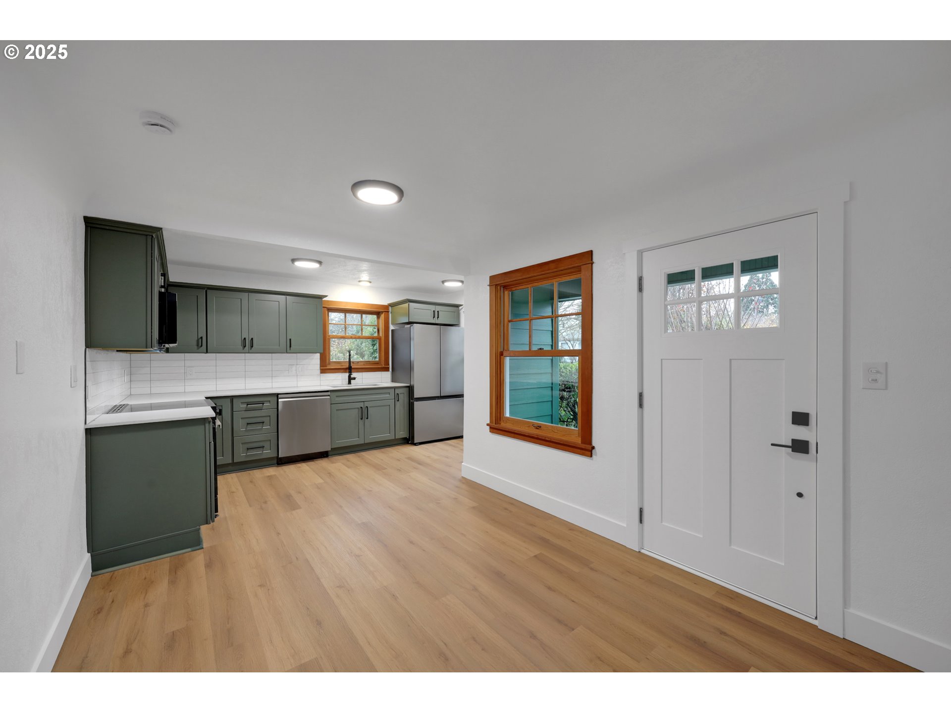 2121 Jefferson Street Eugene, OR 97405 - Photo 8 of 35 a large white kitchen with a sink and cabinets