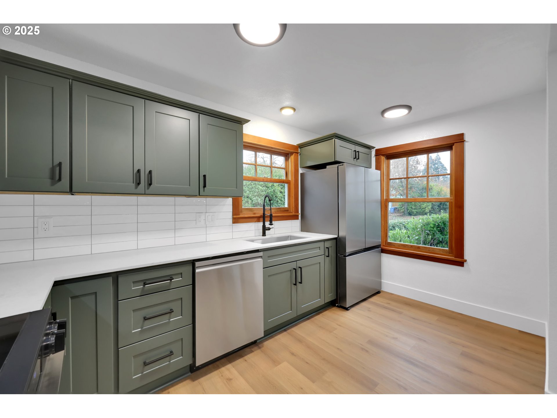 2121 Jefferson Street Eugene, OR 97405 - Photo 10 of 35 a kitchen with stainless steel appliances granite countertop a sink cabinets and wooden floor
