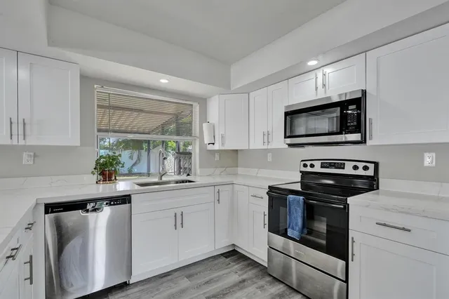 a kitchen with a sink stove and microwave