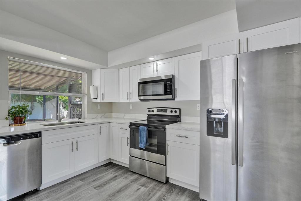 6411 Southwest 6th Street Margate, FL 33068 - Photo 12 of 48 a kitchen with stainless steel appliances a refrigerator stove and sink