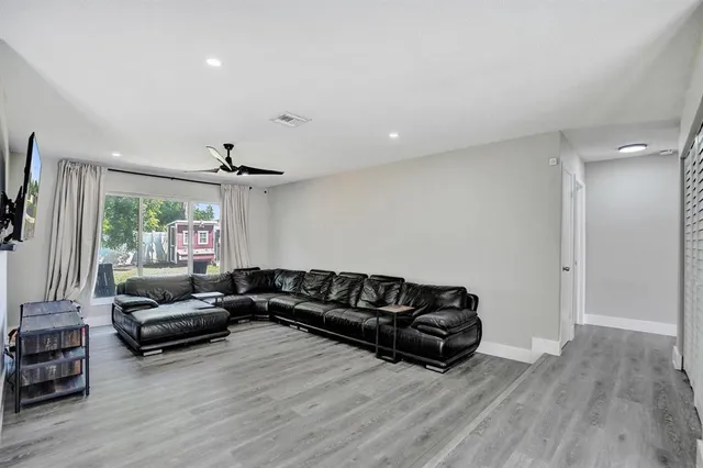 a living room with furniture window and wooden floor