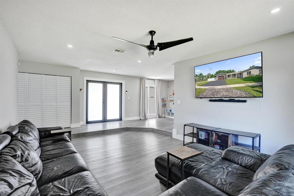 6411 Southwest 6th Street Margate, FL 33068 - Photo 18 of 48 a living room with furniture and a flat screen tv