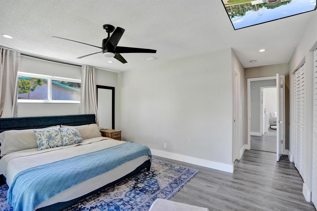 6411 Southwest 6th Street Margate, FL 33068 - Photo 20 of 48 a bedroom with a bed and wooden floor