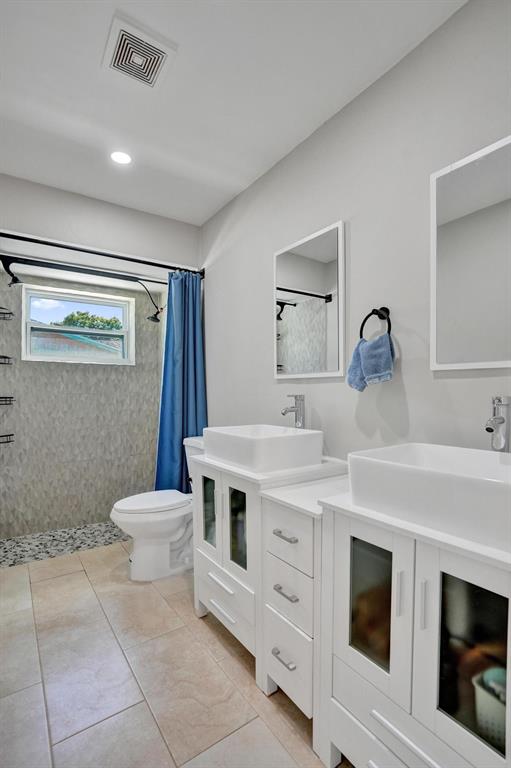 6411 Southwest 6th Street Margate, FL 33068 - Photo 23 of 48 a bathroom with a toilet sink and mirror