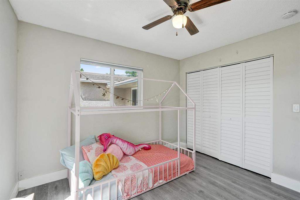 6411 Southwest 6th Street Margate, FL 33068 - Photo 26 of 48 a bedroom with furniture and a ceiling fan