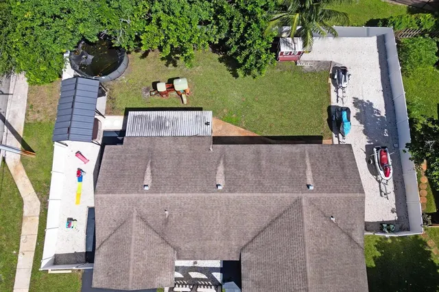 an aerial view of a house with a yard