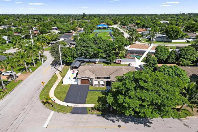 an aerial view of residential houses with outdoor space and street view
