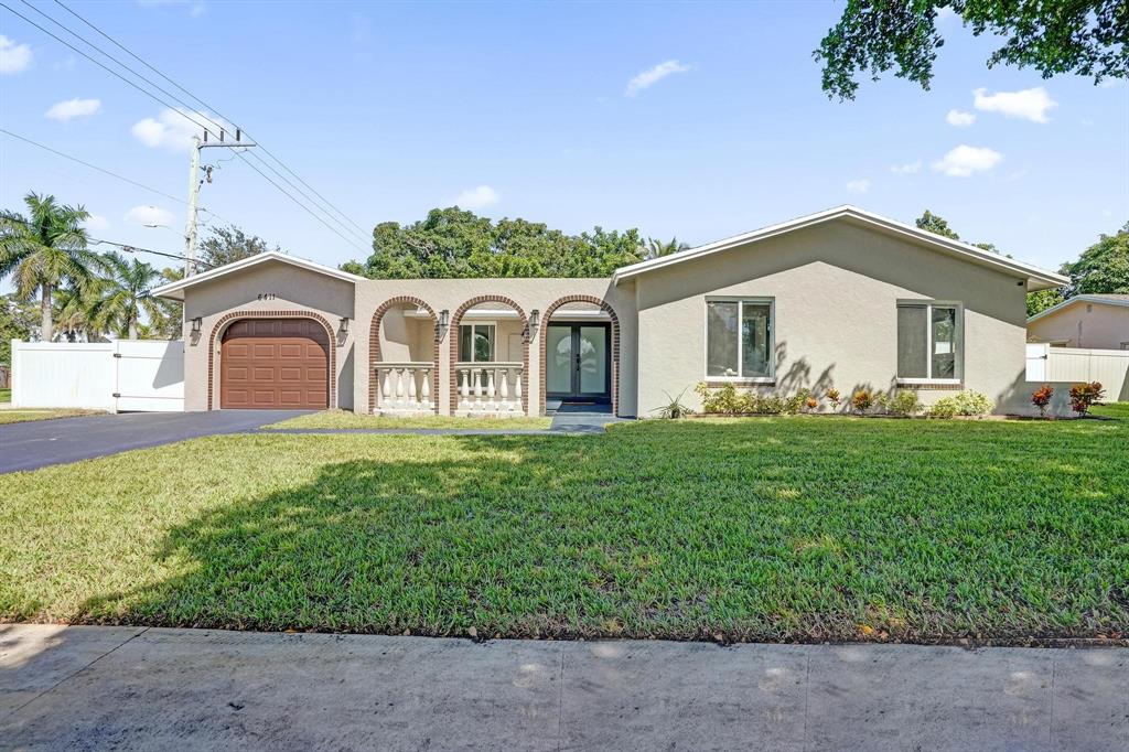 6411 Southwest 6th Street Margate, FL 33068 - Photo 9 of 48 a front view of a house with a garden