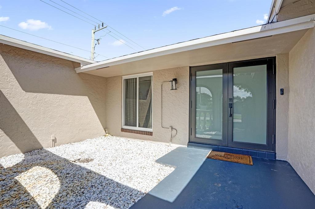 6411 Southwest 6th Street Margate, FL 33068 - Photo 10 of 48 a bedroom with a bed and a large window