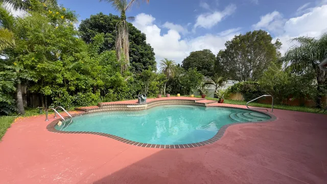 a view of a swimming pool with a yard