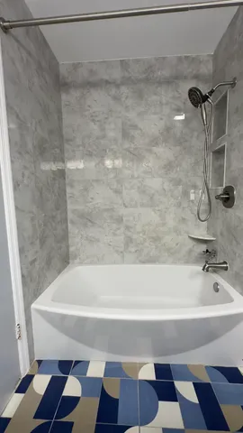 a bathroom with a bathtub and a shower