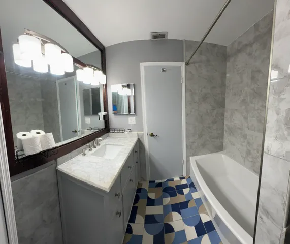 a bathroom with a sink a toilet and a mirror