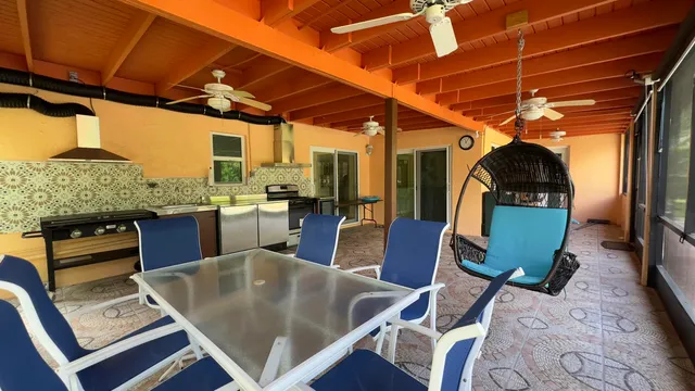 a living room with stainless steel appliances kitchen island granite countertop furniture and a kitchen view